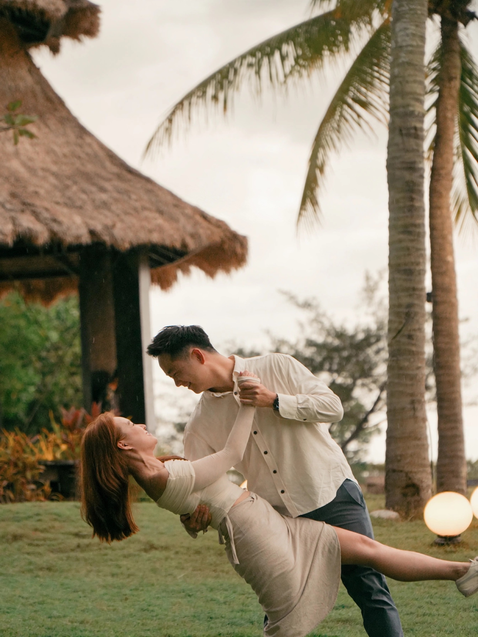 Ian dipping Phylicia under palms in a cinematic frame